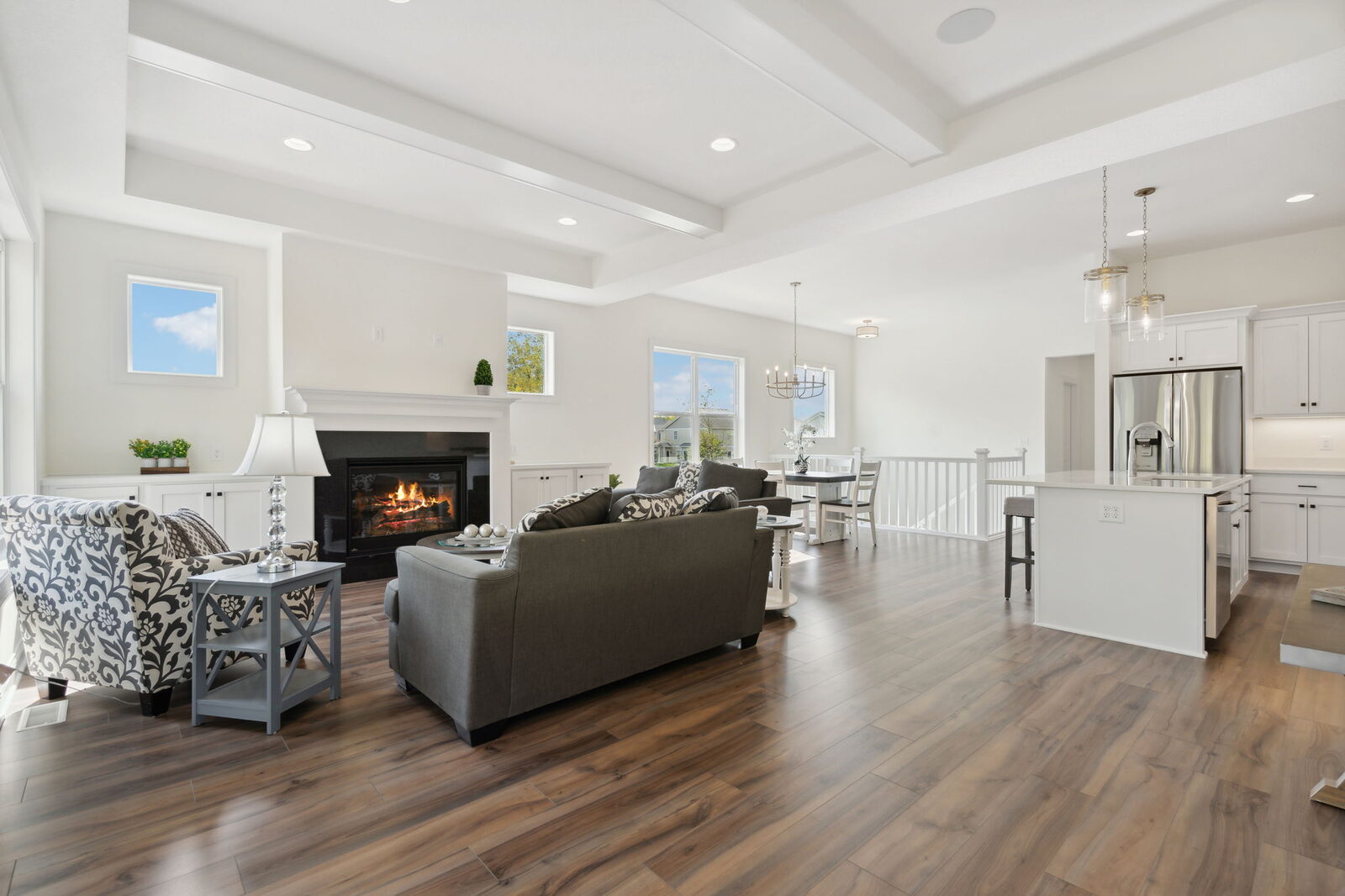Bright great room with fireplace and beamed ceiling