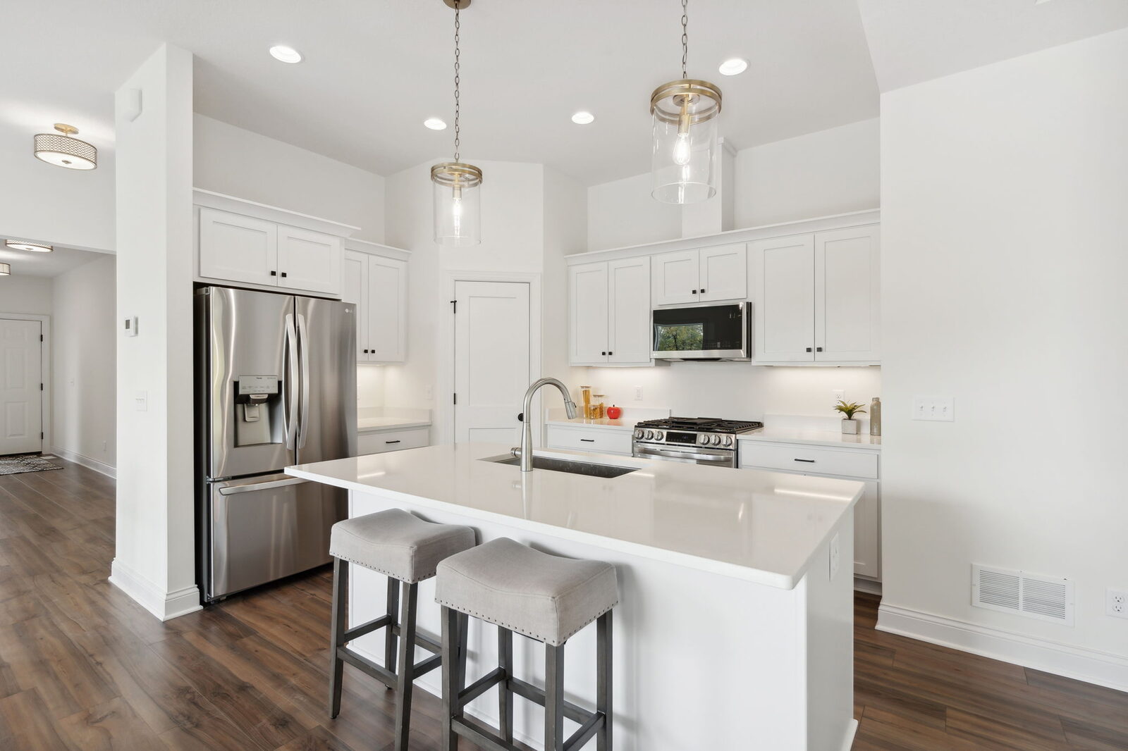 White kitchen with island and pendant lights