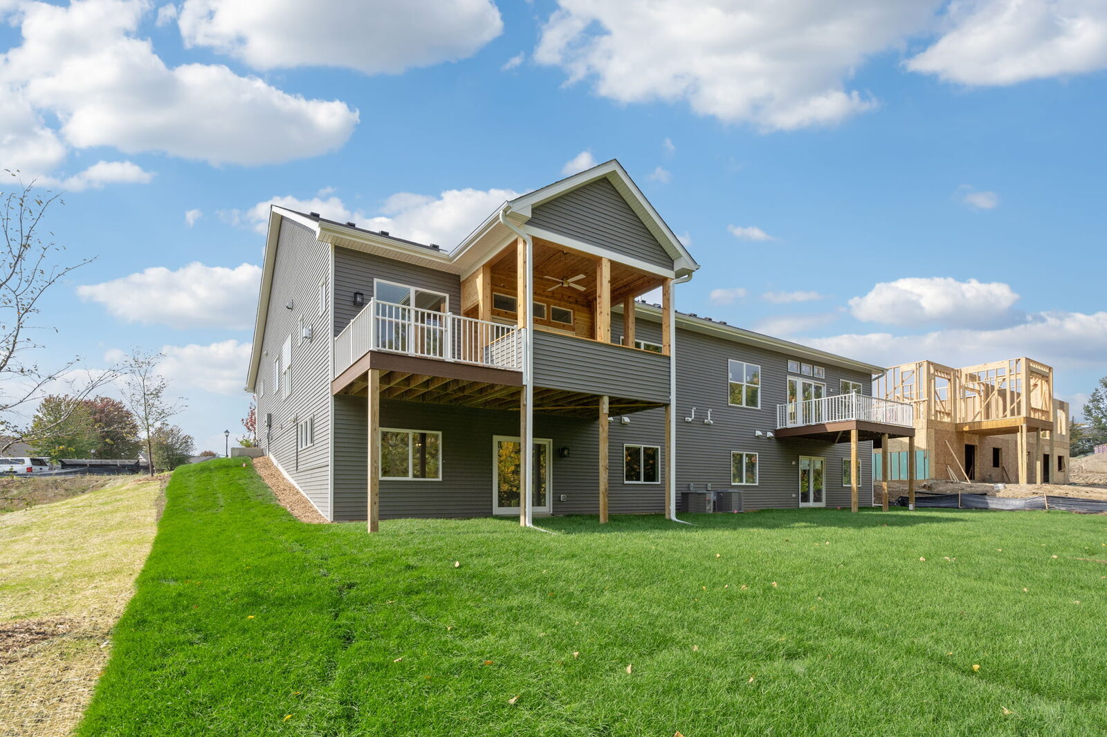 Walkout twin homes with decks and green lawn at Fox Briar Ridge East